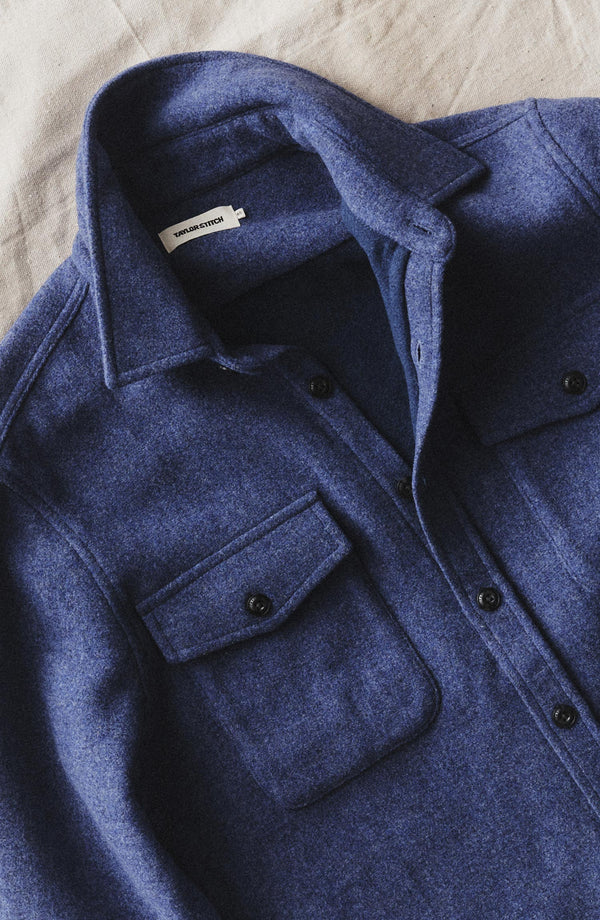 editorial flatlay of The Maritime Shirt Jacket in Heather Navy Wool