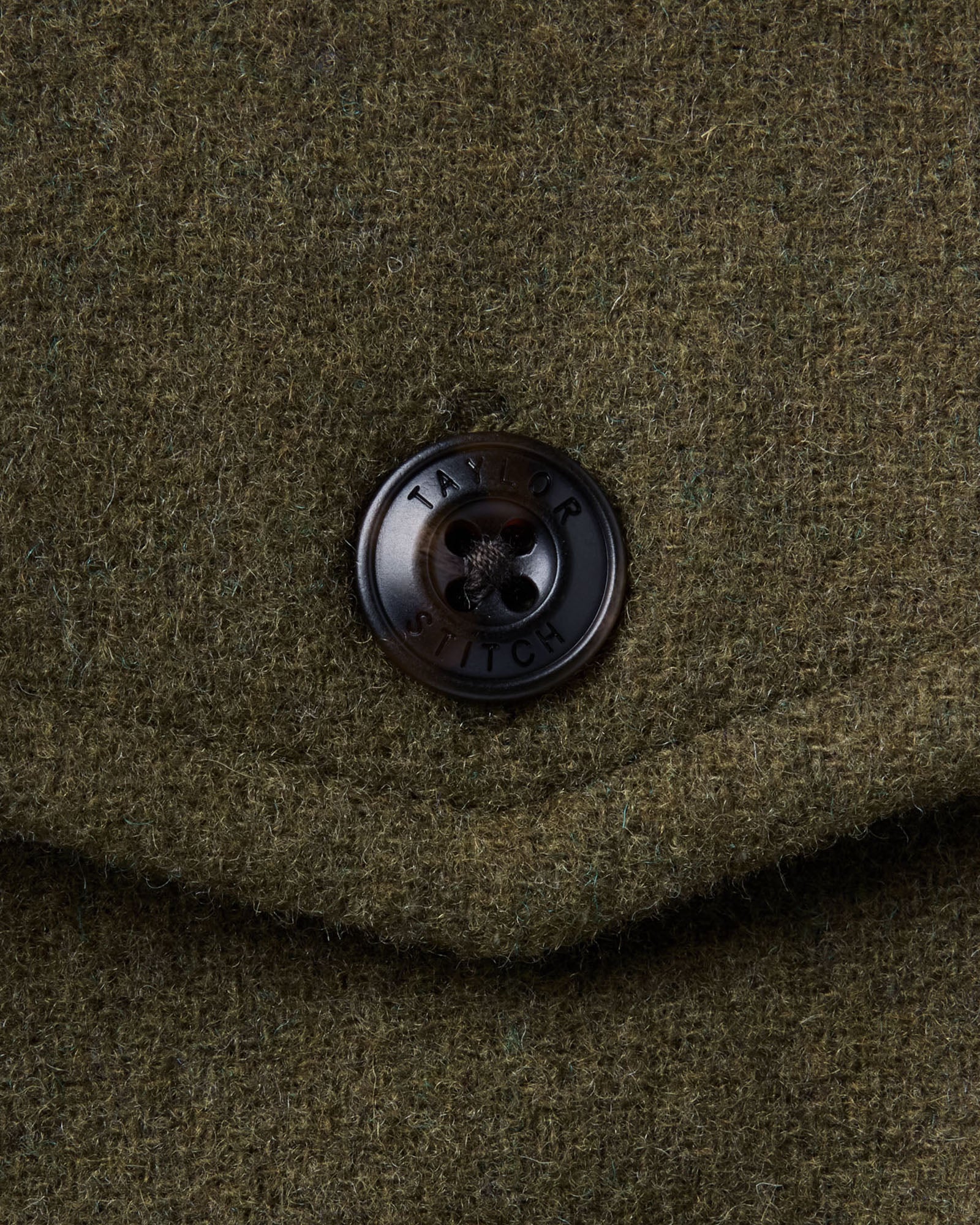 material shot of the button on The Maritime Shirt Jacket in Heather Olive Wool, Outerwear by Taylor Stitch