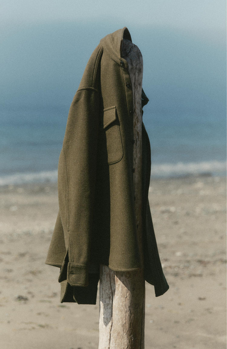 fit model posing in The Maritime Shirt Jacket in Heather Olive Wool