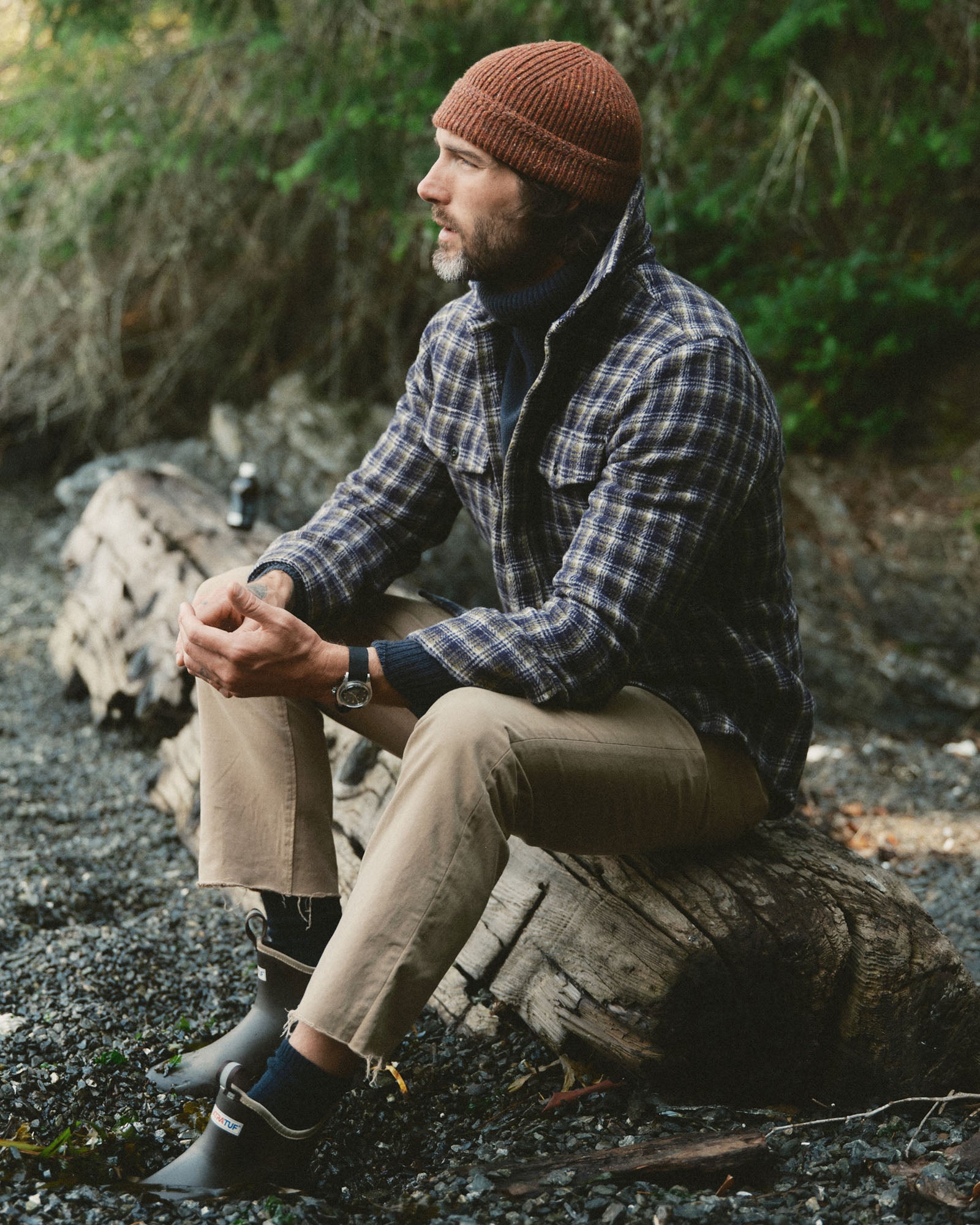 fit model sitting wearing The Maritime Shirt Jacket in Navy Shadow Plaid Wool, Outerwear by Taylor Stitch
