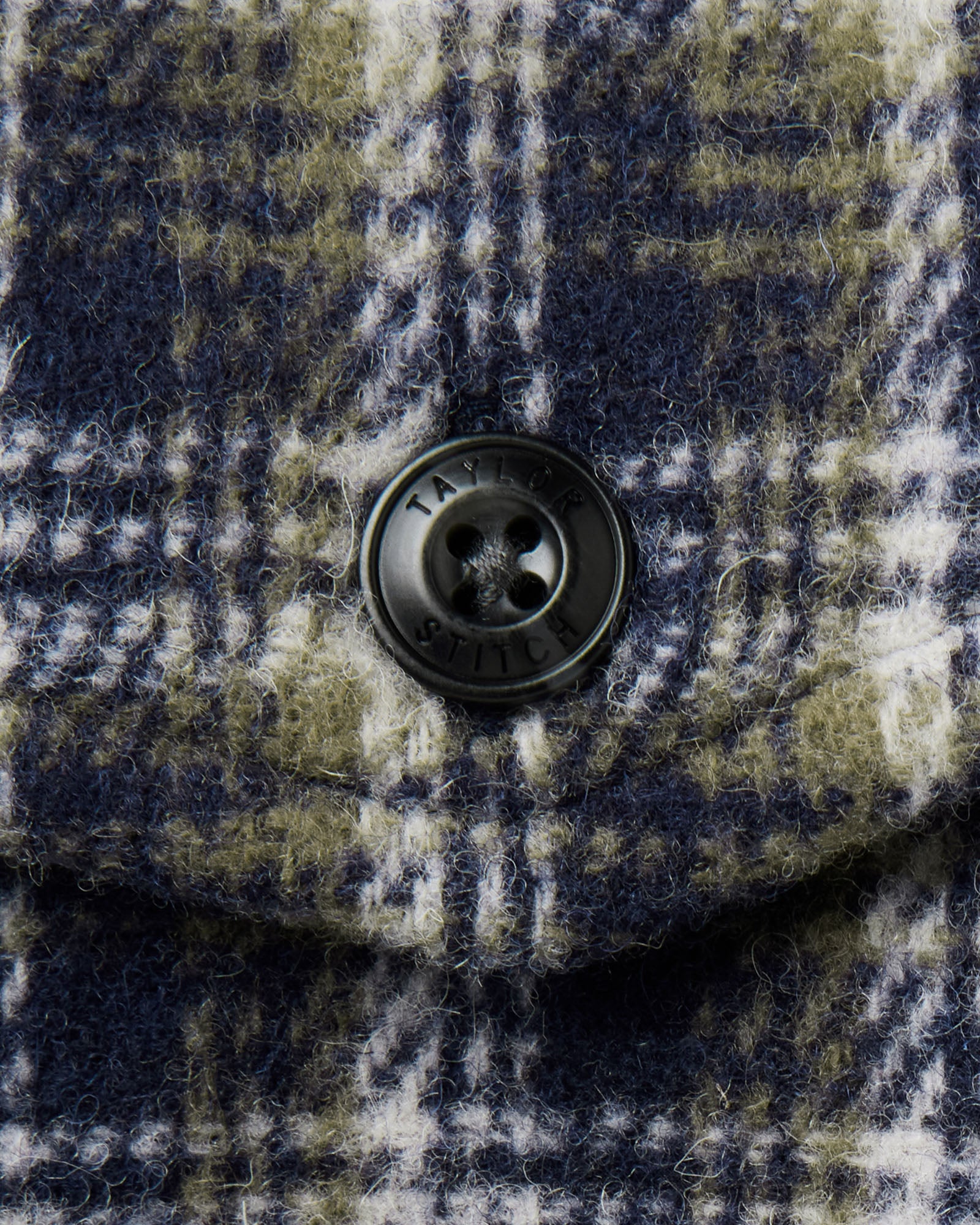 material shot of the button on The Maritime Shirt Jacket in Navy Shadow Plaid Wool, Outerwear by Taylor Stitch