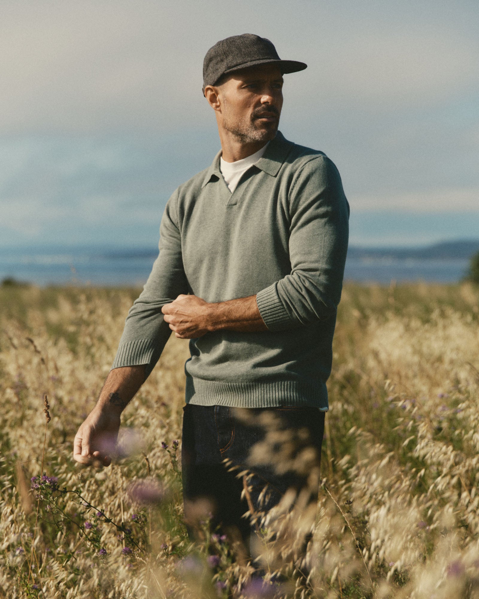 fit model in a field wearing The Mercer Cap in Walnut Herringbone Wool, Accessories by Taylor Stitch