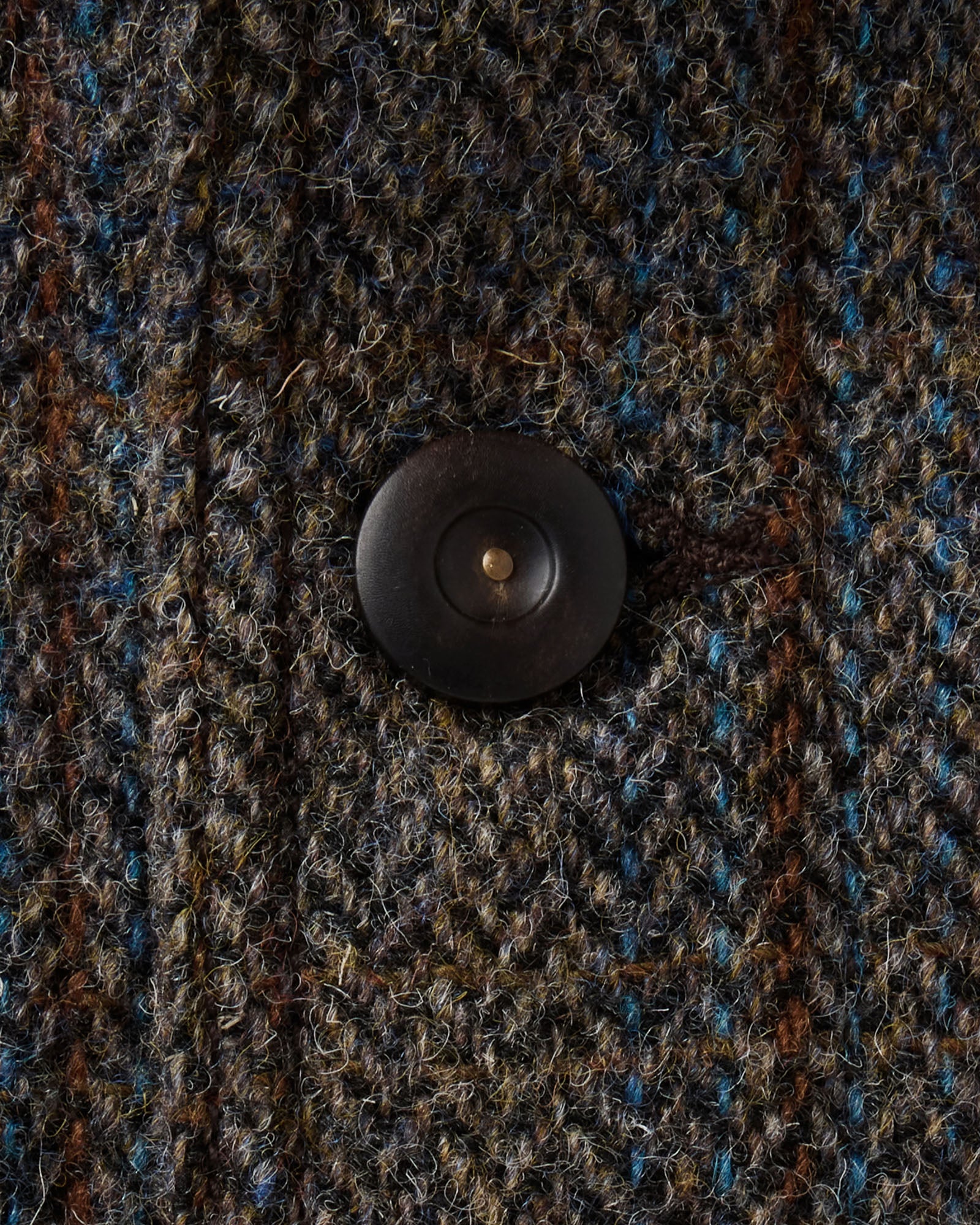 material shot of the button on The Ojai Jacket in Rust Check Harris Tweed Wool, Outerwear by Taylor Stitch