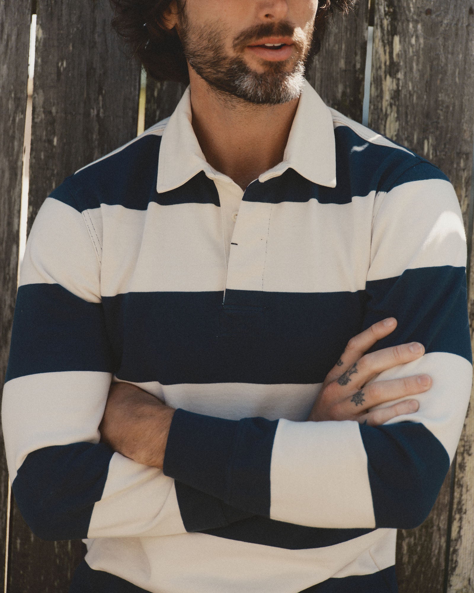 fit model showing off The Rugby Shirt in Navy Stripe, Knits by Taylor Stitch