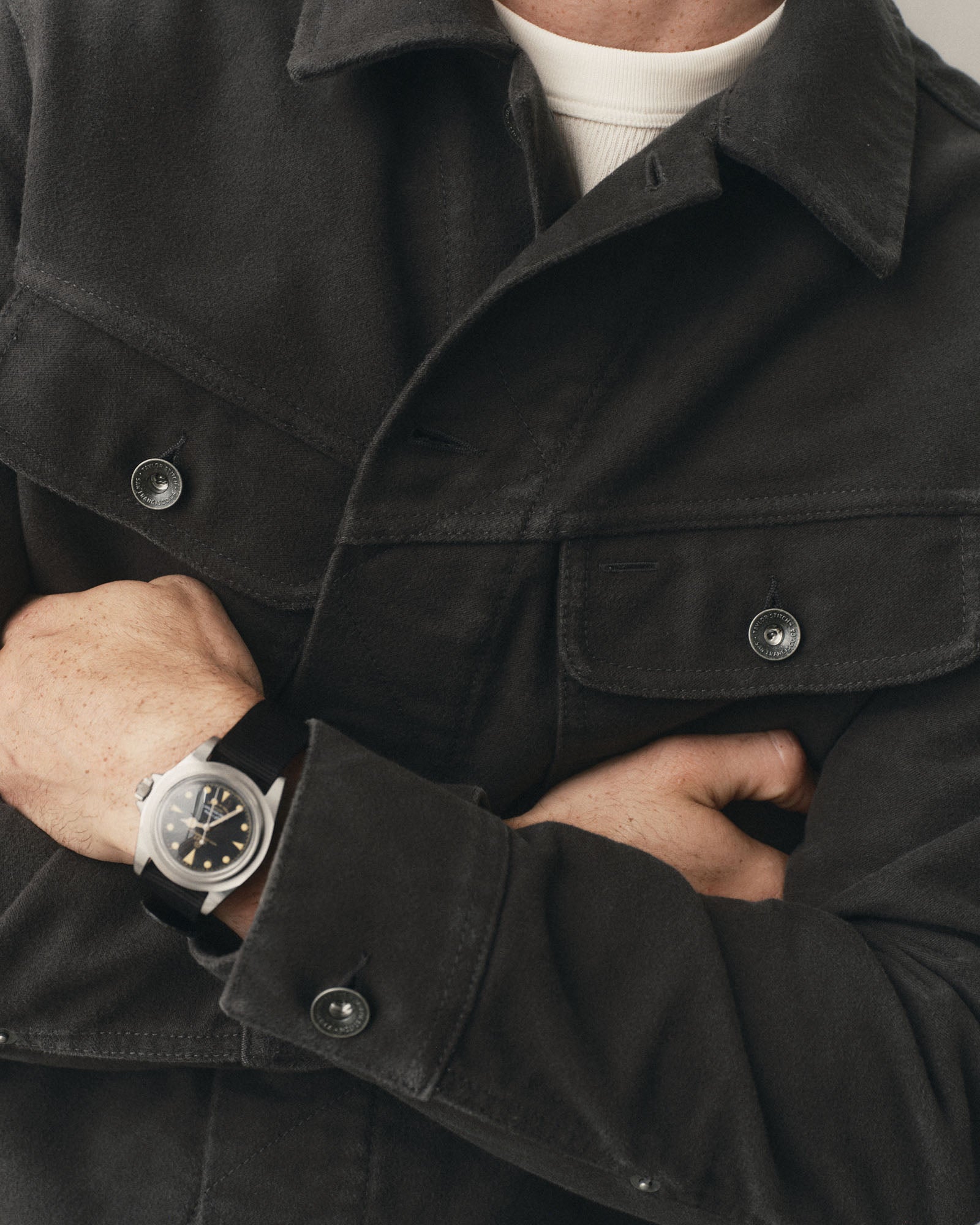 fit model with his arms crossed wearing The Long Haul Jacket in Faded Black Washed Moleskin, Outerwear by Taylor Stitch