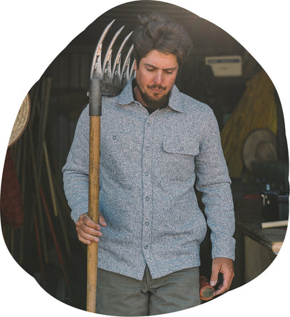 Volunteer at The Ecology Center holding a rake in The Breaker Overshirt in Ash