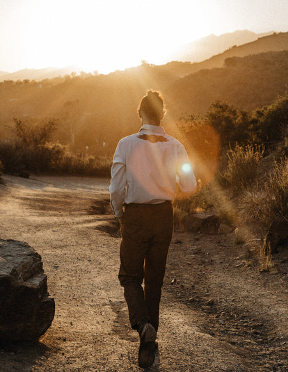 Daren Magee walking on a sunny trail in The Embroidered Western in Washed Selvage