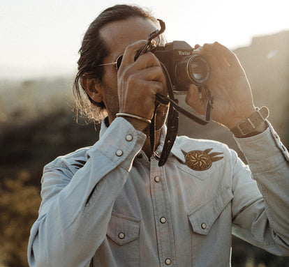 Daren Magee taking a photograph in The Embroidered Western Shirt in Washed Selvage