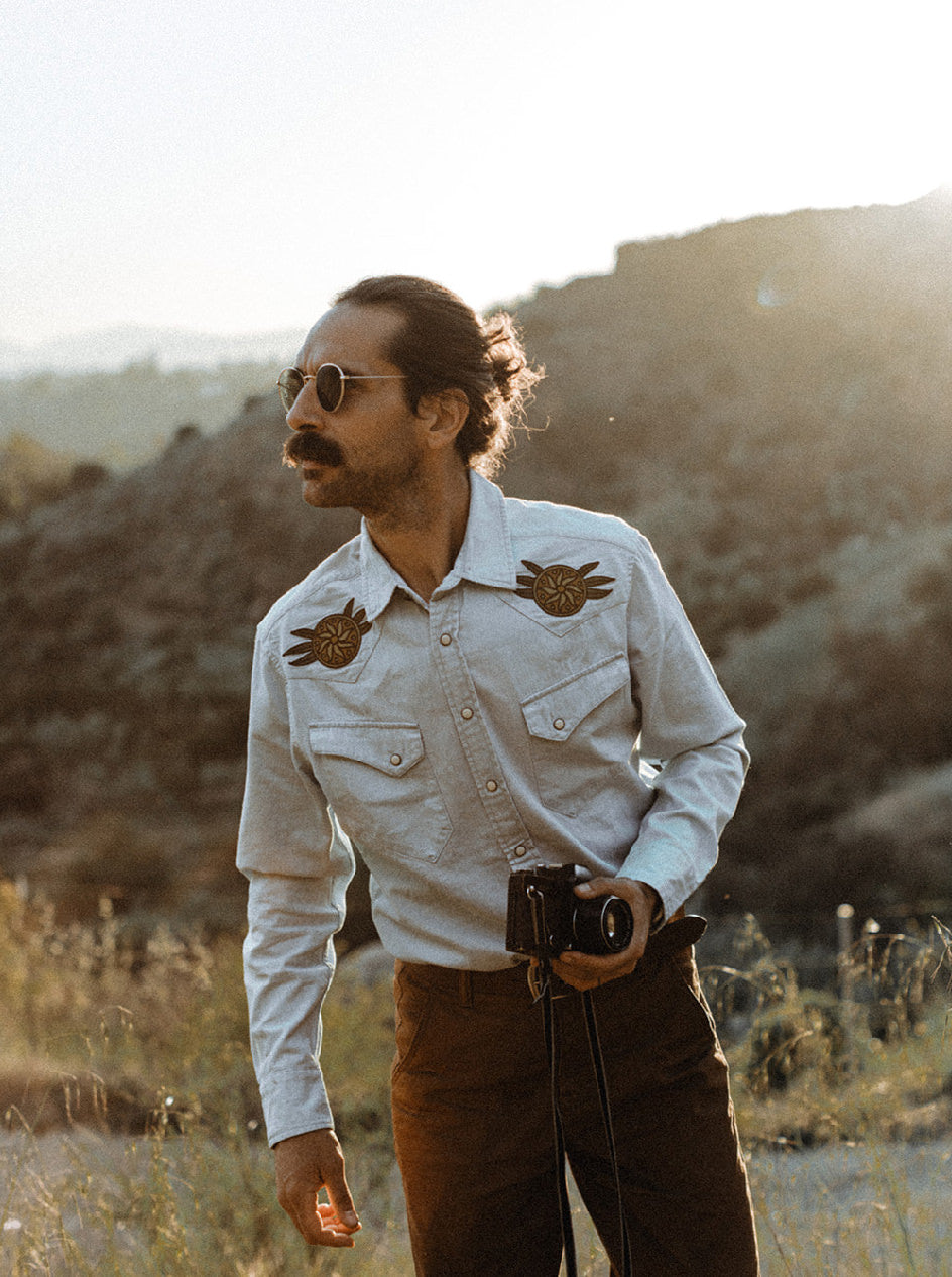 Daren Magee holding a camera in The Western Shirt in Washed Selvage