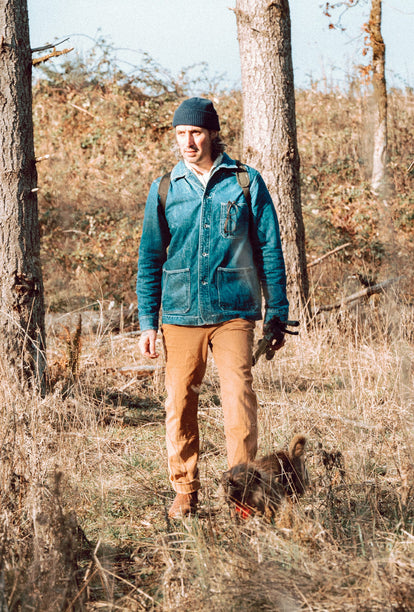 Zach wearing The Ojai Jacket in Sawyer Wash and The Chore Pant in Tobacco Boss Duck while hiking along the Oregon Coast.