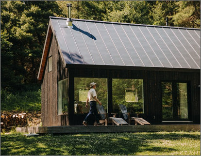 Mark Holthusen walking on the deck of the wooden and glass barn at Springhill Farm