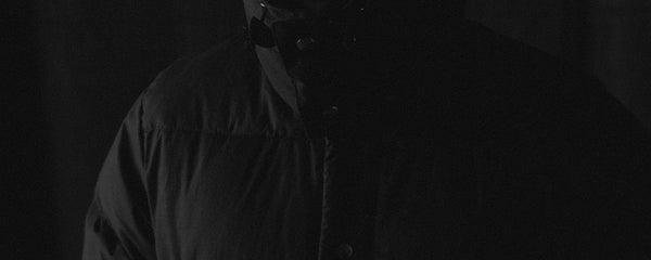 fit model posing in The Down Sweater in Olive Waxed Ripstop