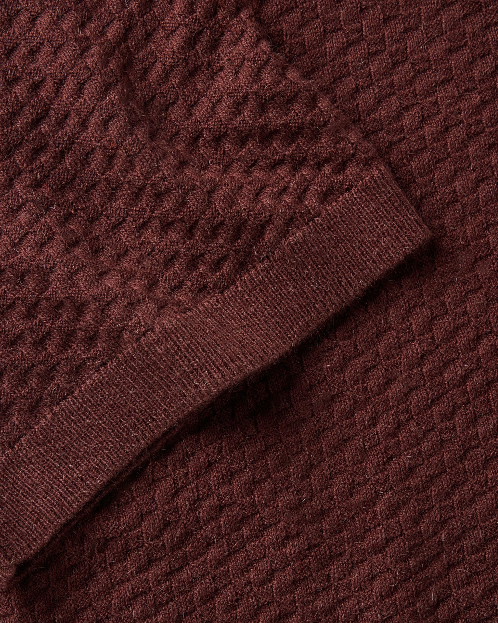 material shot of the sleeve on The Arlo Sweater Polo in Burgundy Texture Knit, Knits by Taylor Stitch