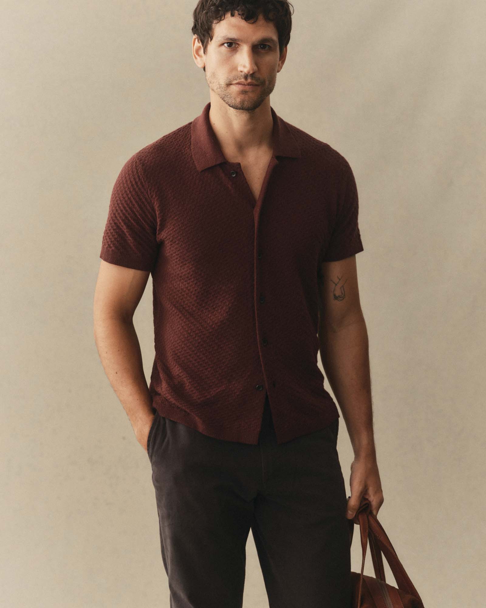 fit model posing in The Arlo Sweater Polo in Burgundy Texture Knit, Knits by Taylor Stitch