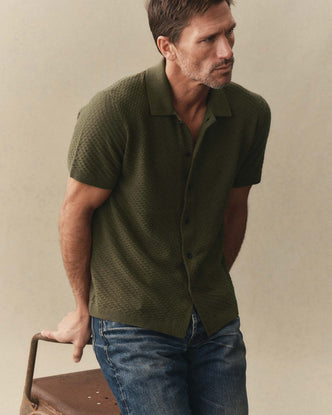 fit model sitting wearing The Arlo Sweater Polo in Cilantro Texture Knit