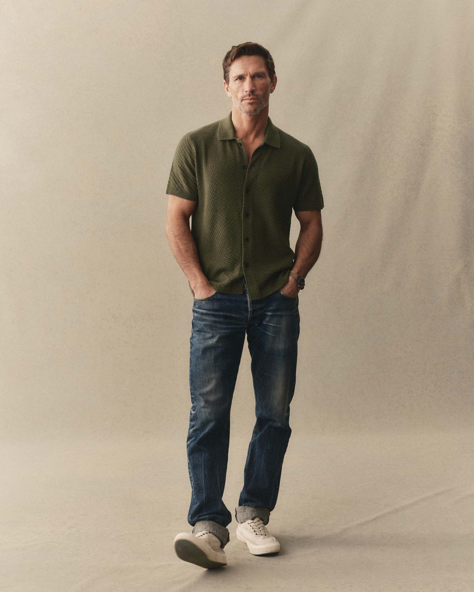 fit model posing in The Arlo Sweater Polo in Cilantro Texture Knit, Knits by Taylor Stitch
