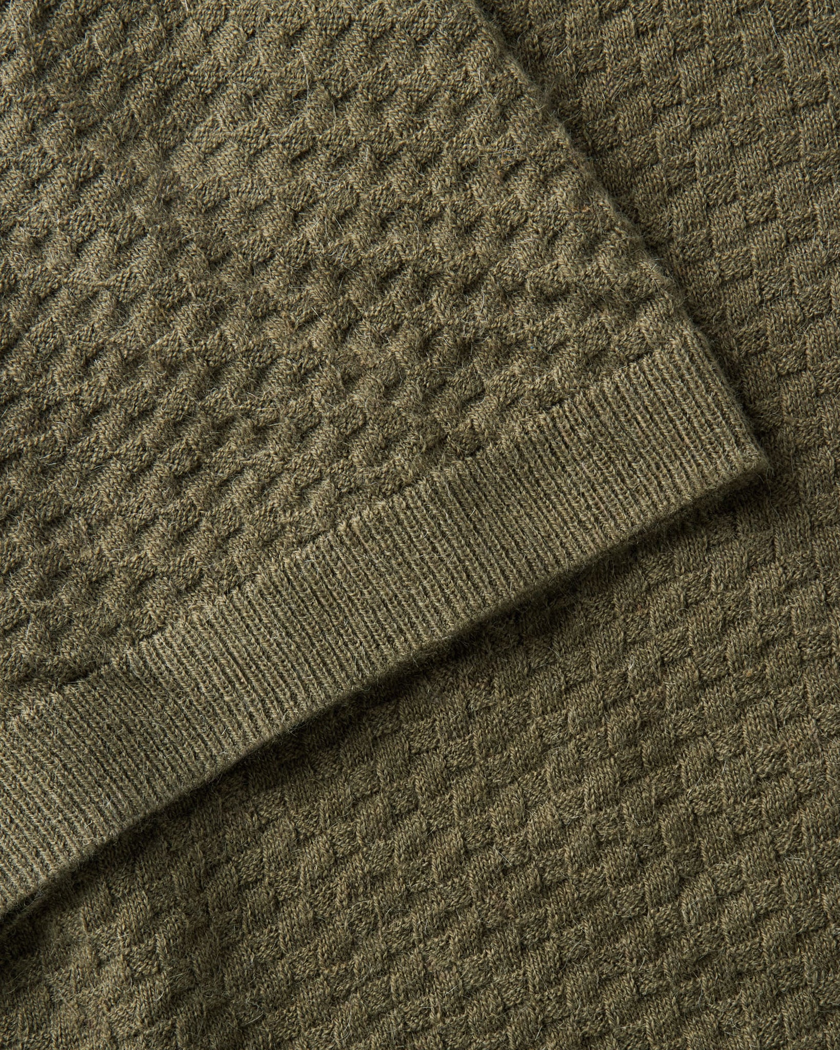 material shot of the sleeve on The Arlo Sweater Polo in Cilantro Texture Knit, Knits by Taylor Stitch