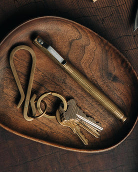 The Keyhook in Raw Brass on a tray, Accessories by Taylor Stitch