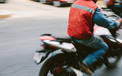 Blurred shot of a motorbike driving out of frame to the right.