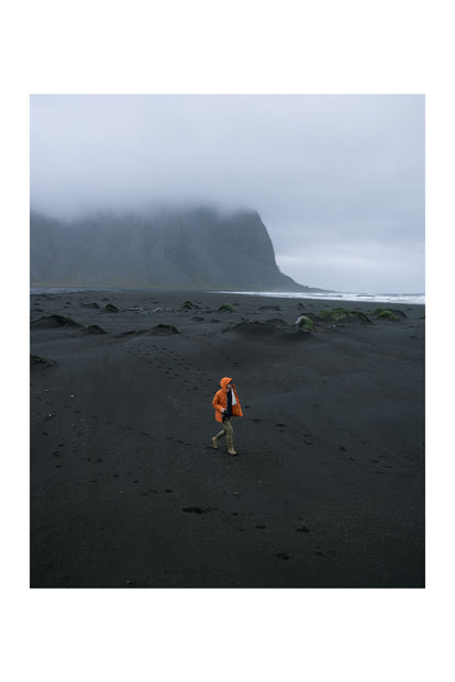 Scott Bakken walking on a black sand beach