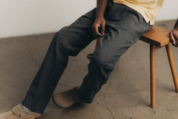 fit model sitting wearing The Breakwater Pant in Charcoal Sashiko