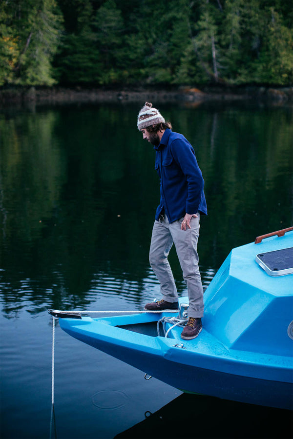 Two surfers paddling out.