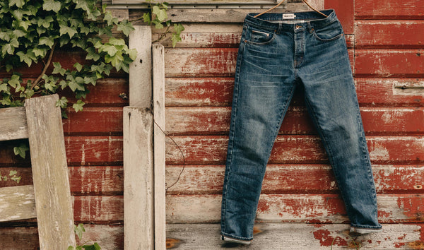 editorial image of The Slim Jean in Mid Wash Organic Selvedge hanging