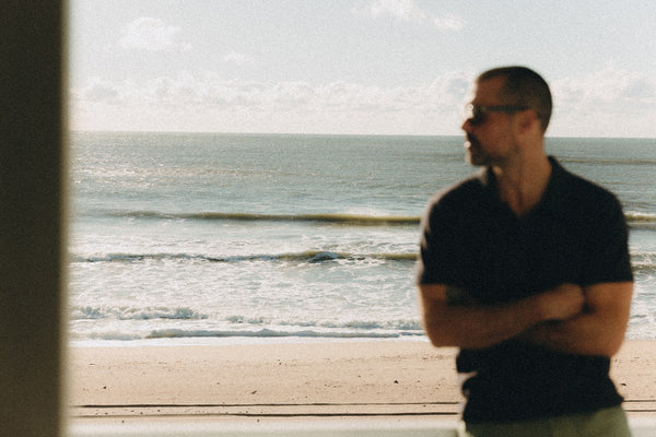 fit model posing in The Merino Polo in Heather Black