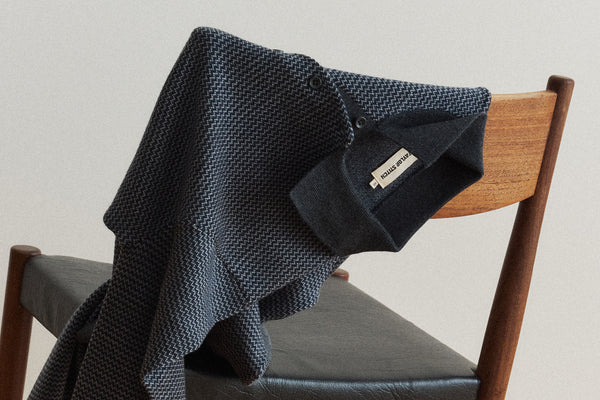 editorial image of The Sweater Polo in Navy hanging