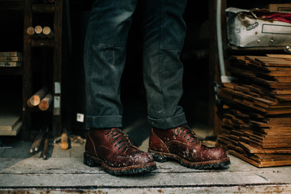 man wearing the backcountry boot in a workshop