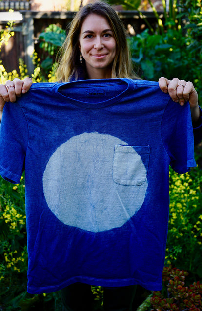 Kristin Arzt's process: holding up a finished tee.