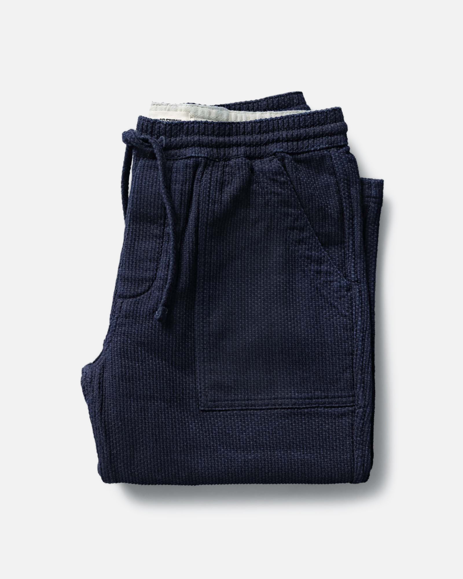 folded flatlay of The Breakwater Pant in Rinsed Indigo Sashiko, Bottoms by Taylor Stitch