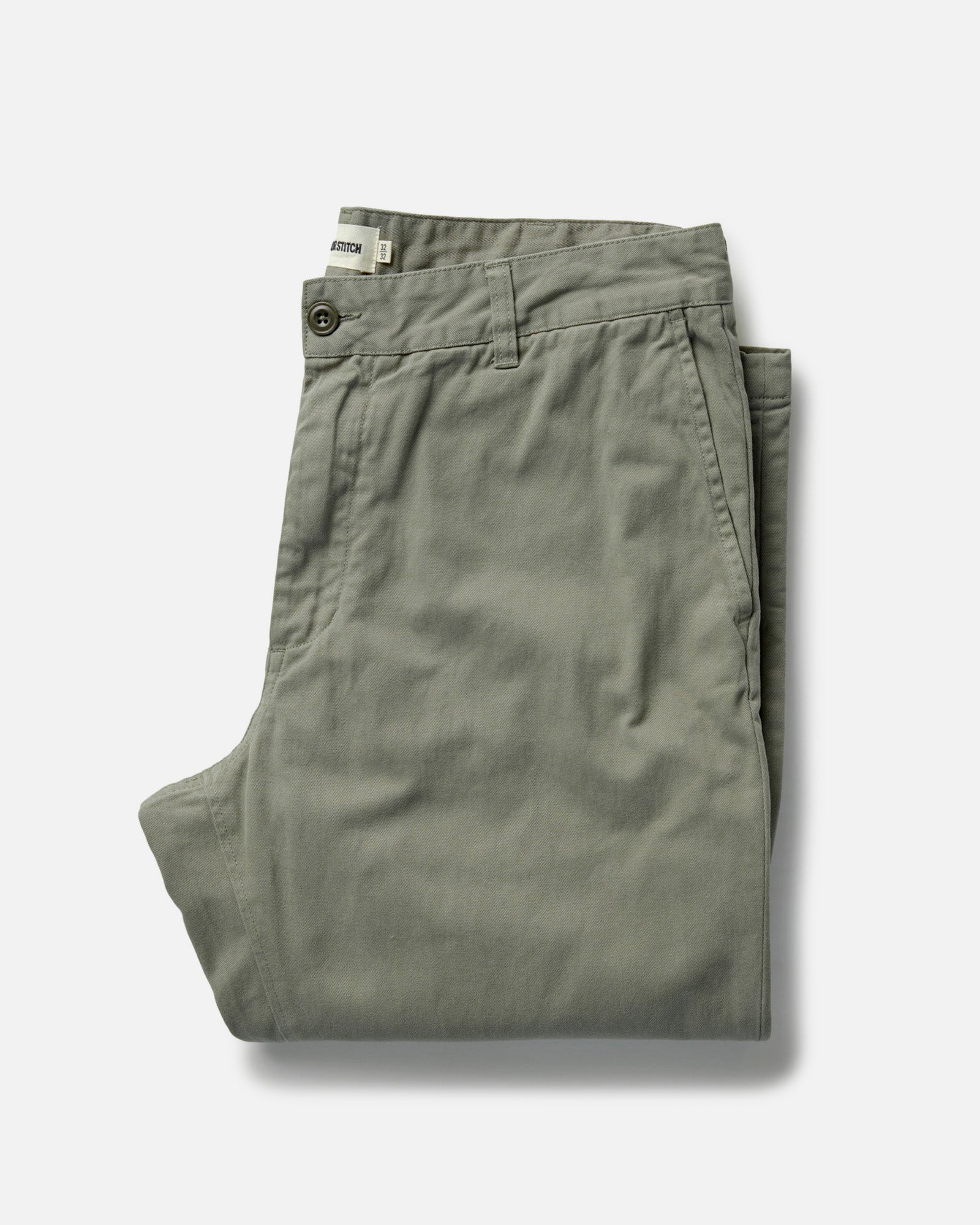 folded flatlay of The Democratic Foundation Pant in Organic Smoked Olive, Bottoms by Taylor Stitch