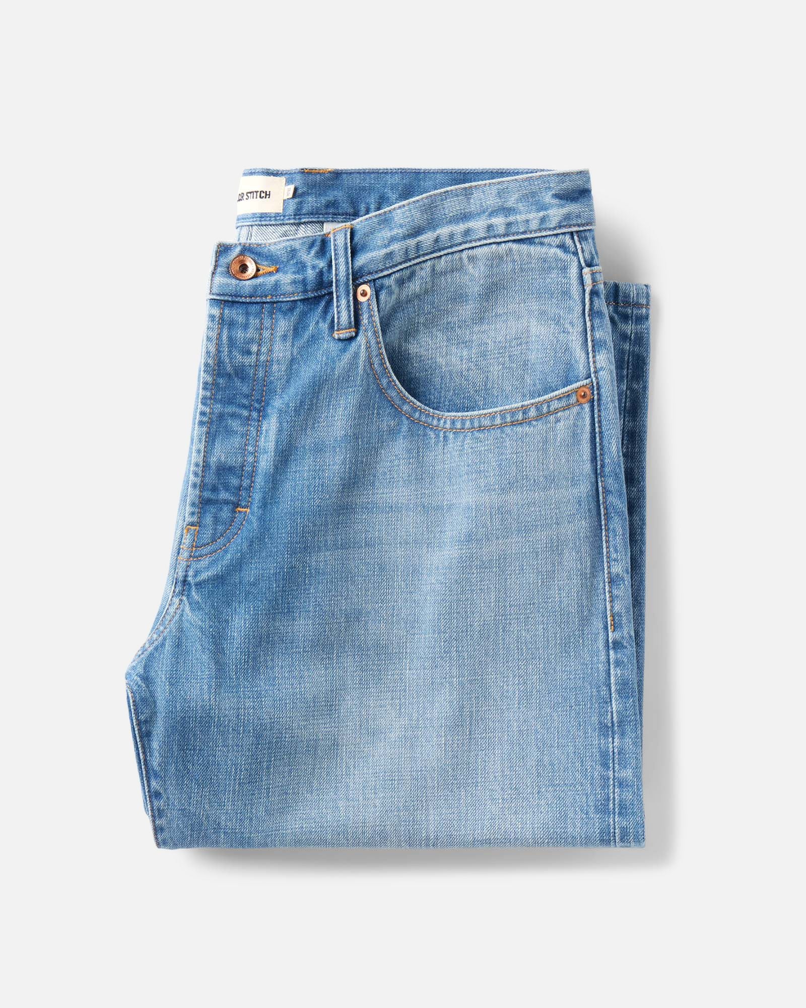 folded flatlay of The Democratic Jean in Light Wash Organic Selvedge, Bottoms by Taylor Stitch