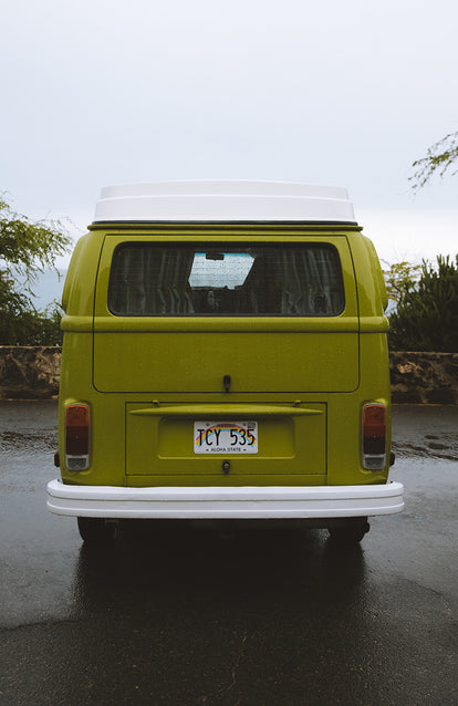 Rear view of a nicely painted green vintage VW bus.