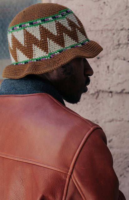 Shot from over the shoulder, showing the collar of a brown leather jacket.