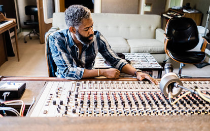 Kirk checking out the levels on a sound board.