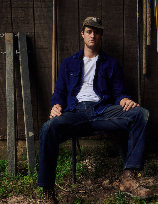 Matt Byrd sitting wearing The Division Shirt in Rinsed Indigo Sashiko