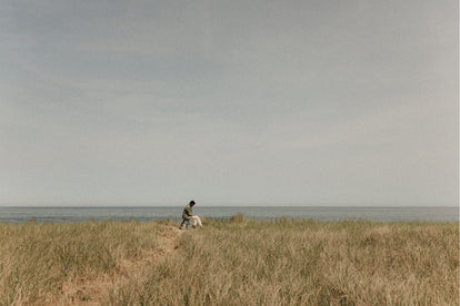 Model sitting on a stool in front of the ocean in Wellfleet