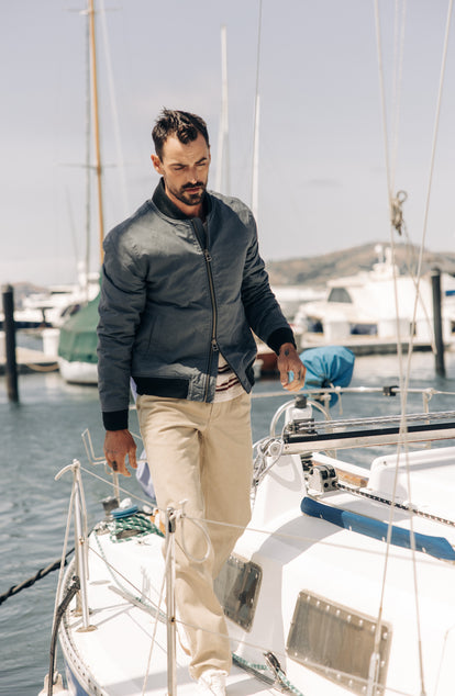 fit model on a boat in The Bomber Jacket in Charcoal Dry Wax