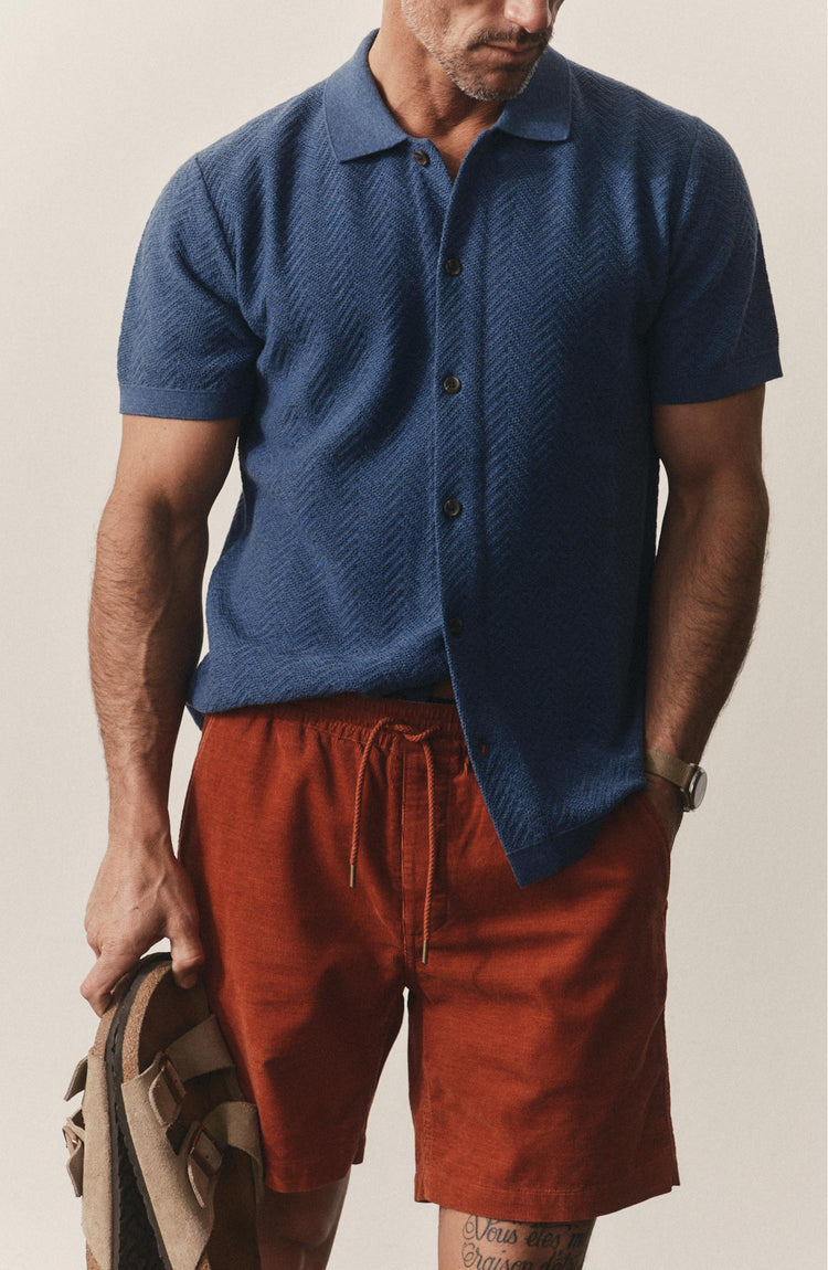 fit model with his hand in his pocket wearing The Button Down Polo in Gulf Stream Herringbone