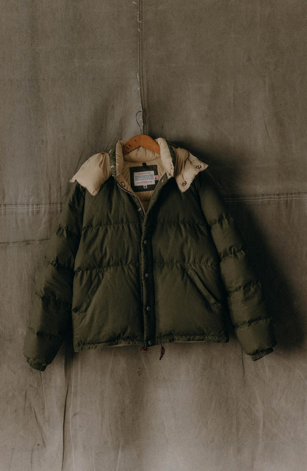 editorial image of The Down Sweater in Olive Waxed Ripstop hanging