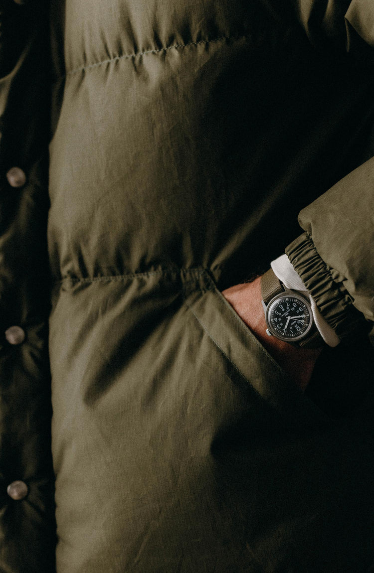 fit model showing off the pockets on The Down Vest in Brick Red Waxed Ripstop
