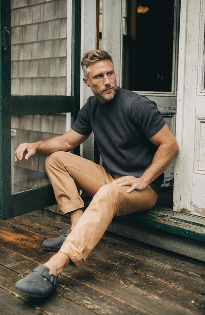 fit model sitting by the door wearing The Democratic All Day Pant in Tobacco Selvage Denim