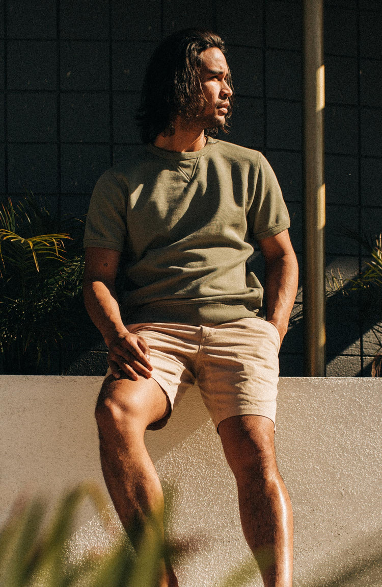 fit model sitting in the foundation short in khaki twill
