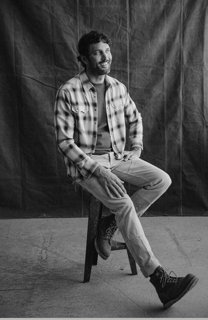 fit model sitting in The Frontier Shirt in Indigo Shadow Plaid