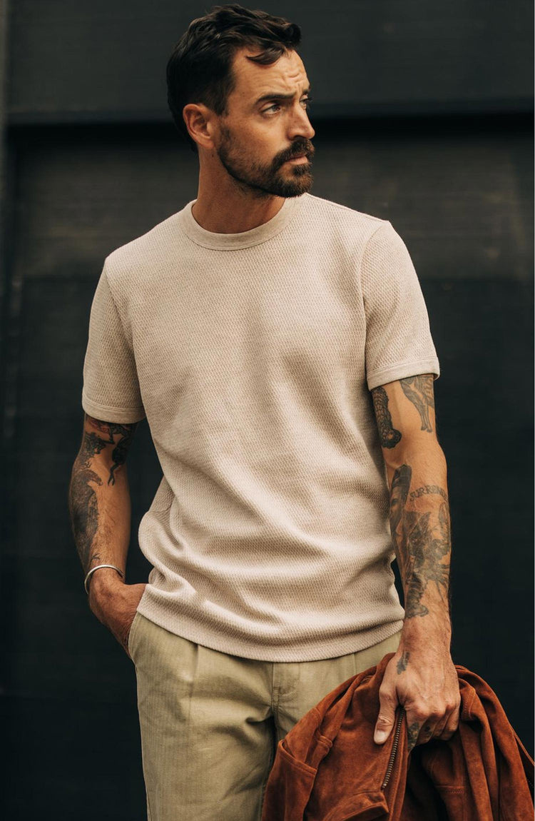 fit model with his hand in his pocket wearing The Heavy Bag Waffle Short Sleeve in Oat Heather