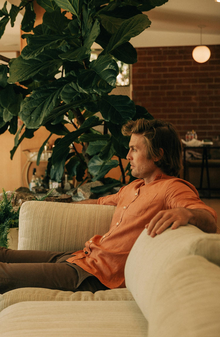 fit model sitting on a couch in the jack in apricot linen
