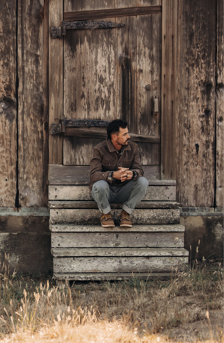 fit model crouching in The Longshore Jacket in Chipped Canvas