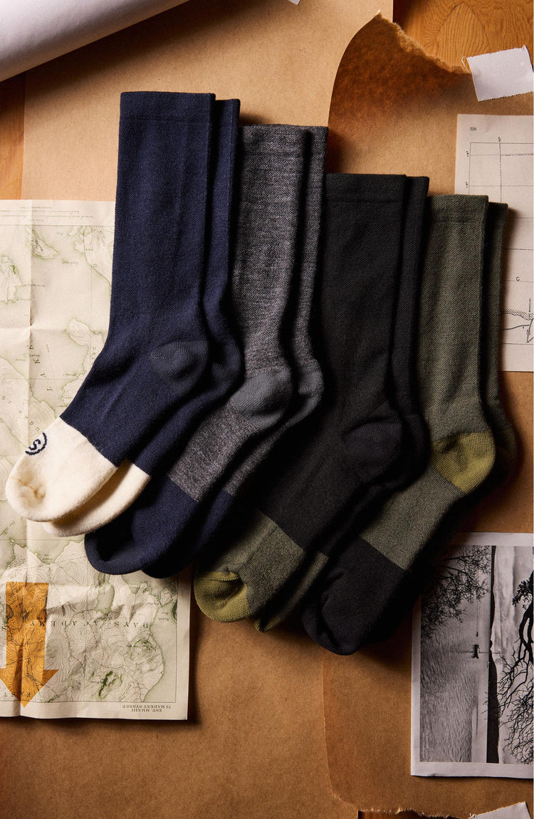 flatlay of various socks including The Merino Sock in Black